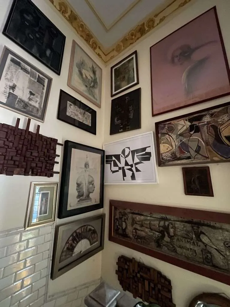 Paintings on a wall in a Cuban underground antiques shop in Havana Cuba