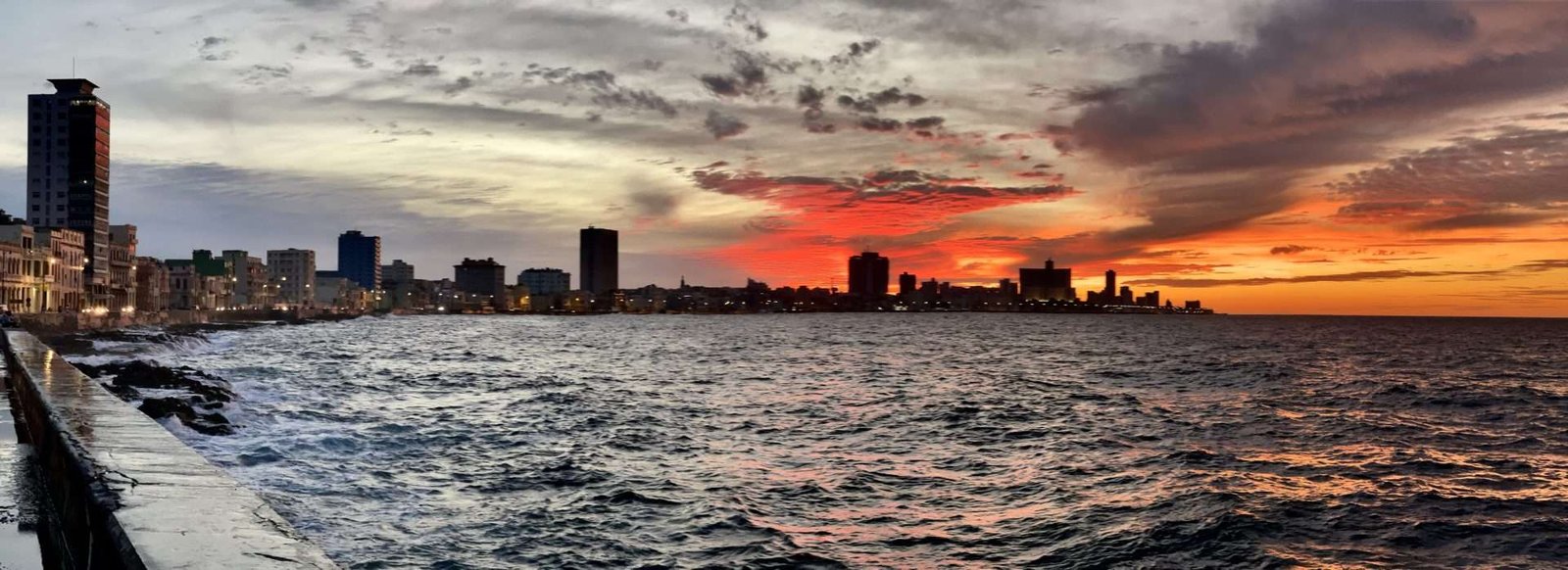 Sunset over the malecon seawall in Havana Cuba