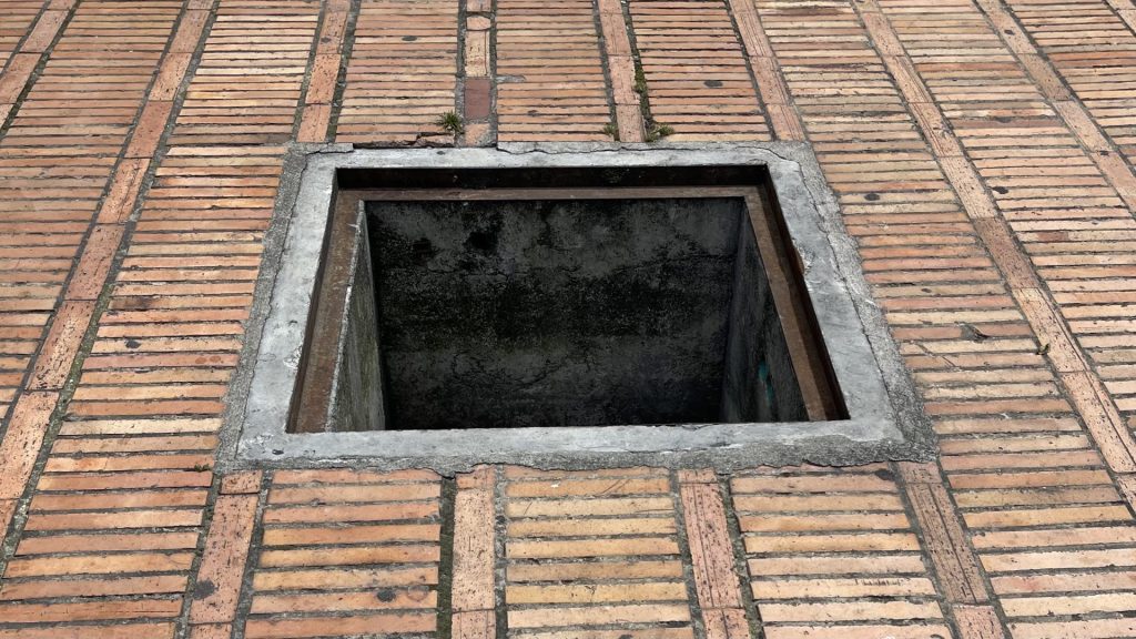 Hole In Bogotá Sidewalk