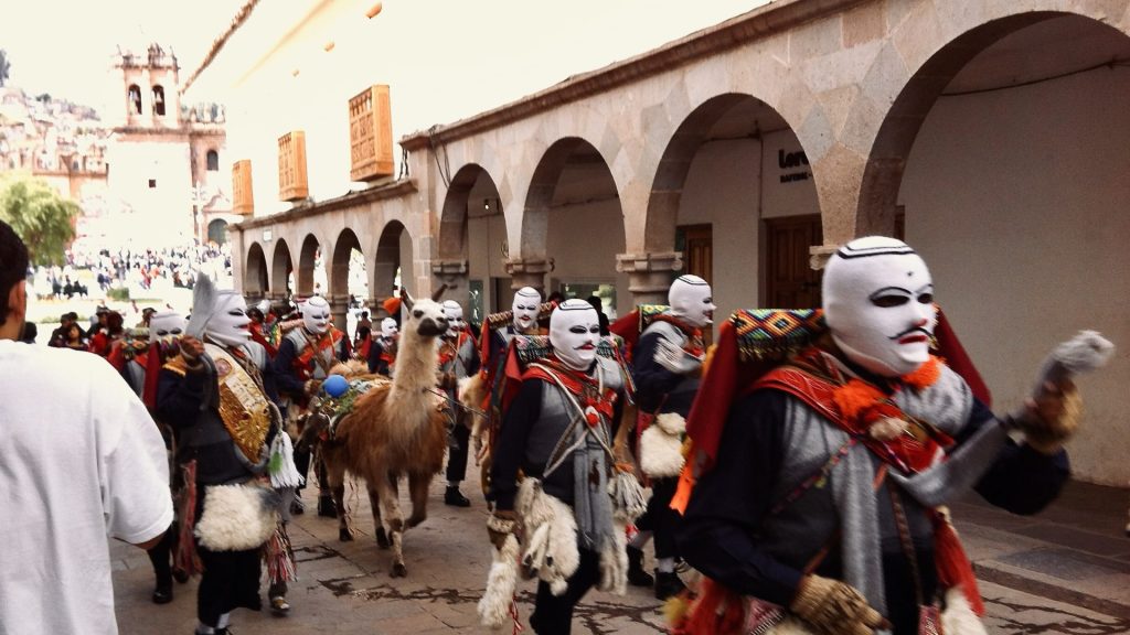 Masked festival goers in Cusco Peru