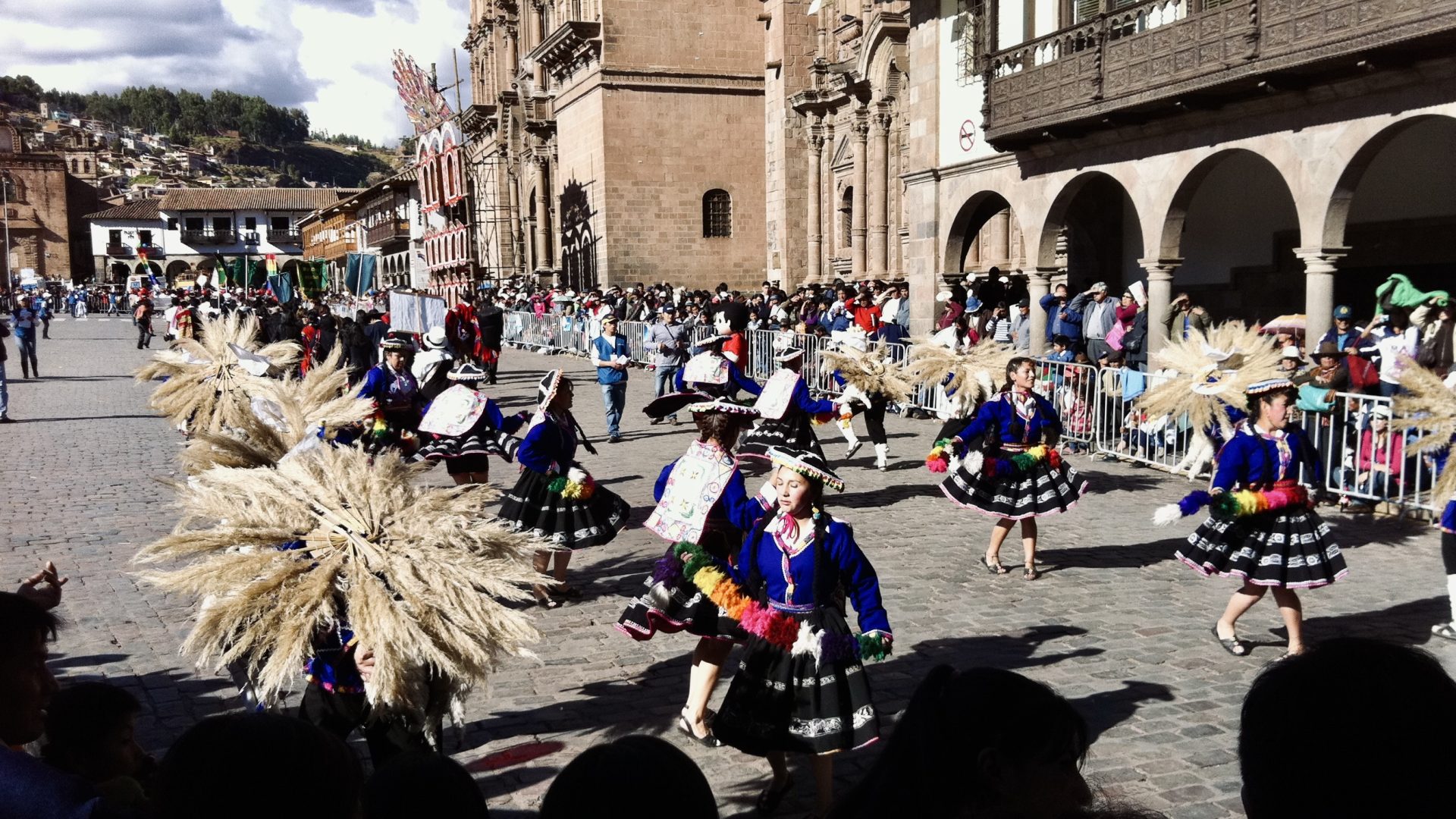 Street performers parade through the streets during Cusco's Inti Raymi festival.