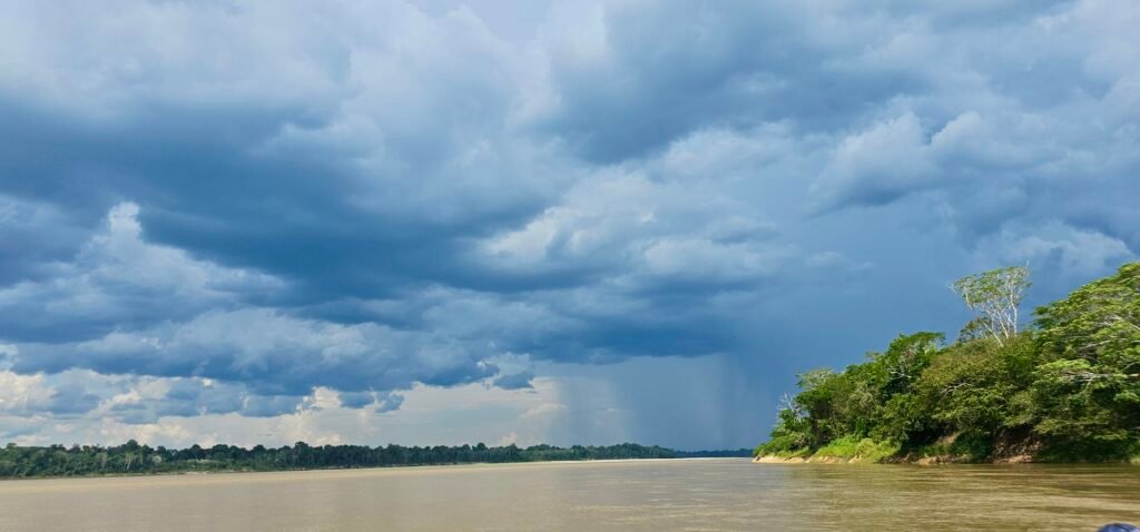 Dramatic storm clouds over the Amazon River in Peru during a private boat expedition.