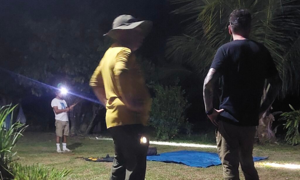 Travelers preparing for a night trek while setting up a base camp at Etson's farm in the Amazon rainforest.