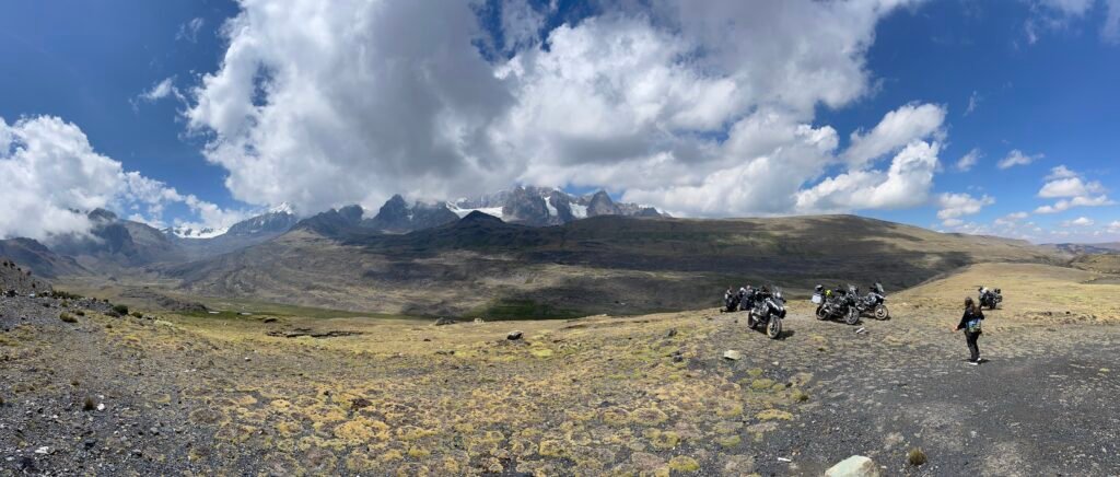 A wide view of the 30C highway winding up the steep, green mountain face of the Peruvian Andes toward the Abra Pirhuayani pass.