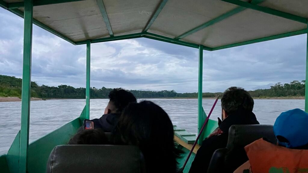 Interior view from a crowded motorized boat during the sunrise commute into the Tambopata National Reserve.