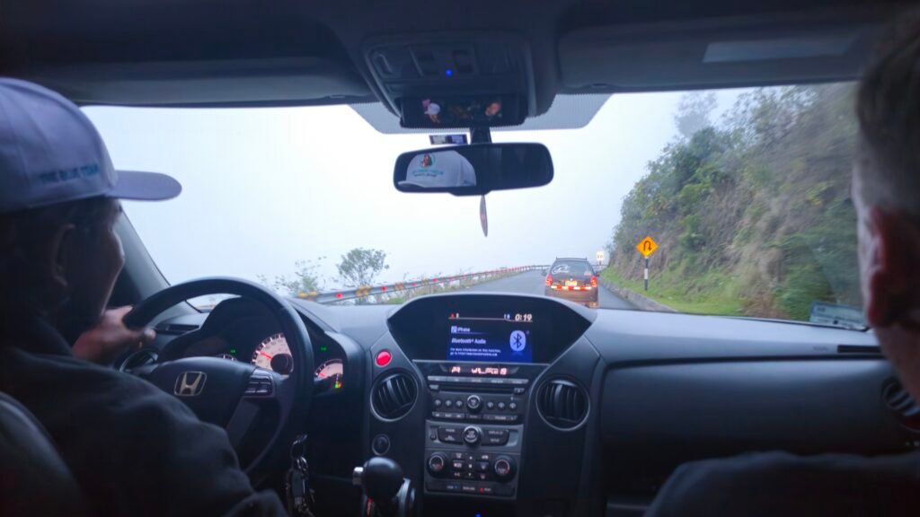 A view from inside a car driving through heavy mountain mist on the winding Interoceanic Highway to Puerto Maldonado.
