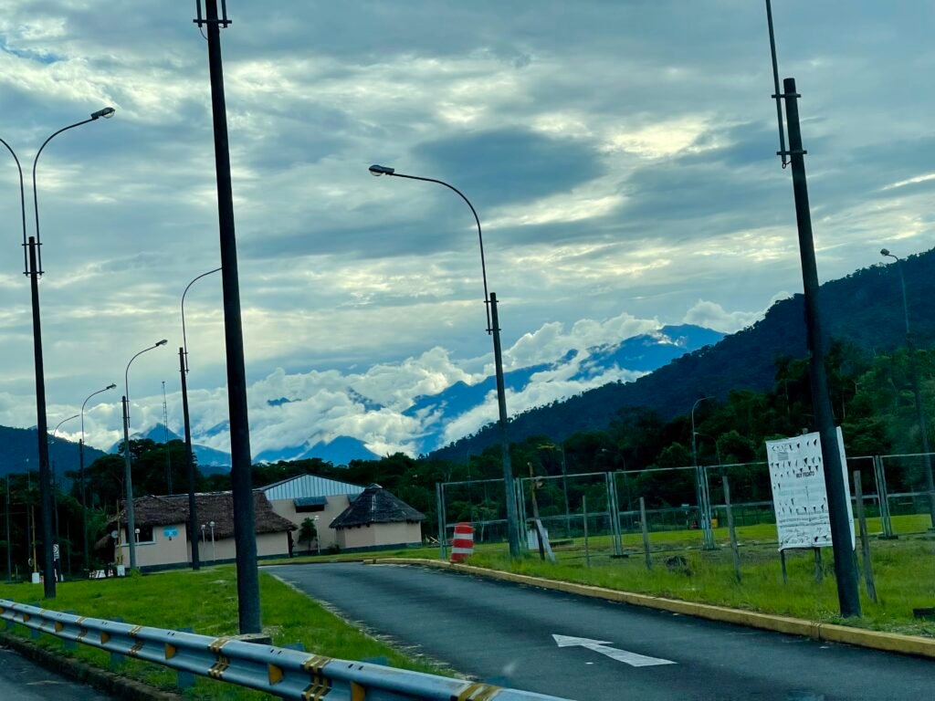 Dramatic green mountain peaks rising above a thick layer of white clouds in the Peruvian cloud forest.