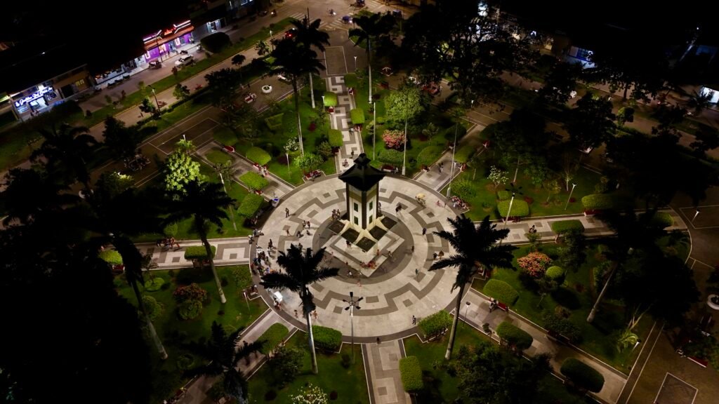 Aerial night view of the illuminated Plaza de Armas in Puerto Maldonado, the administrative hub of the Madre de Dios region.