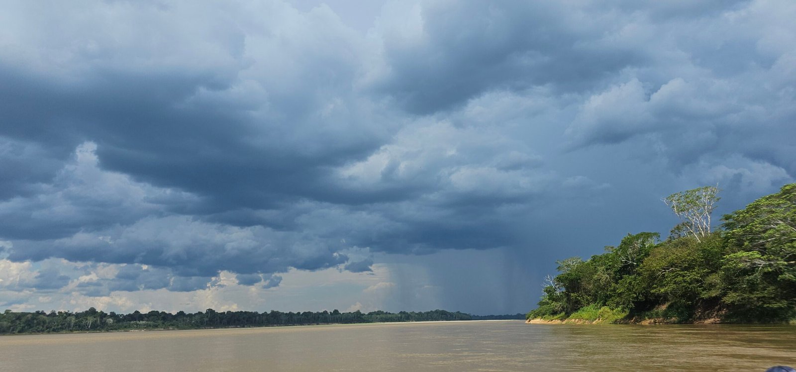 Stormy sky and rain clouds over the Madre de Dios River, downstream from the Tambopata confluence in the Peruvian Amazon.