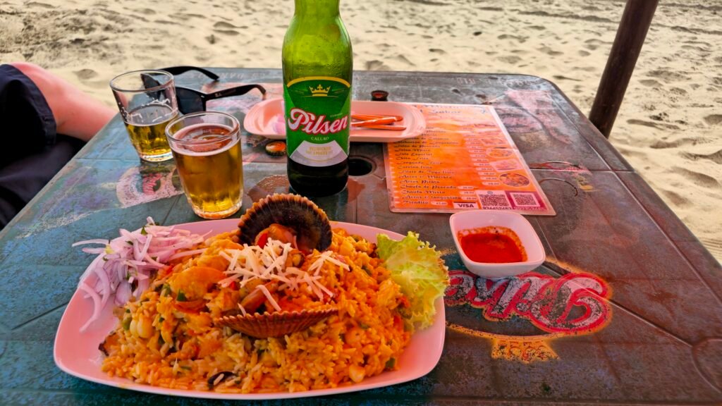 A fresh plate of ceviche and a cold Pilsen Callao beer served on a table at Playa Colorado.