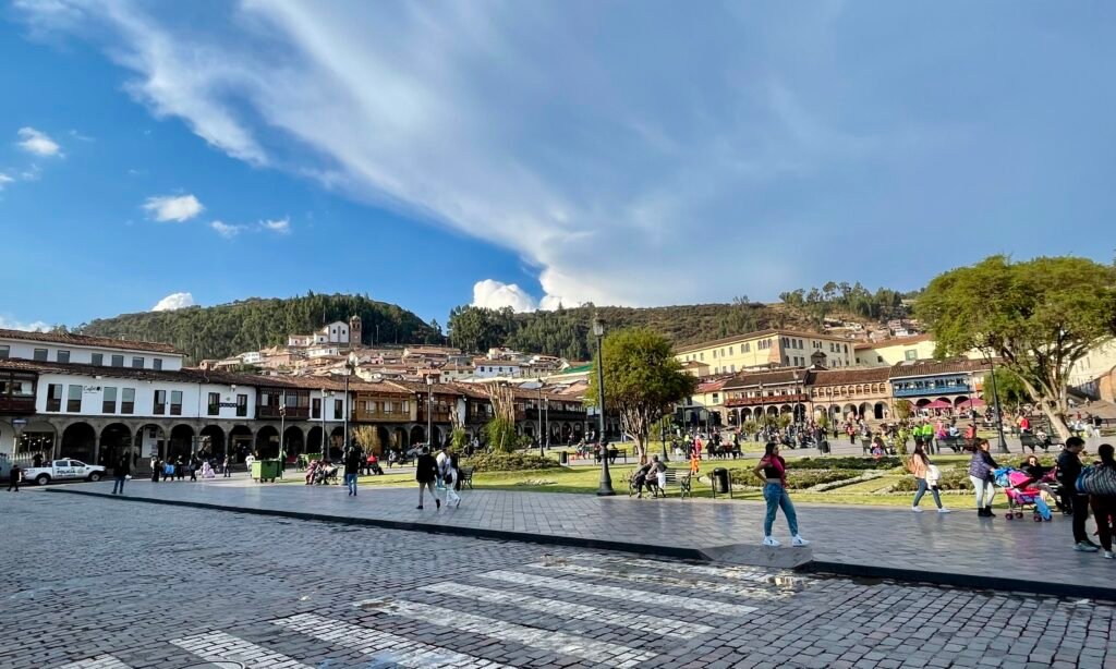 View from the Plaza de Armas looking up toward the Cristo Blanco statue that overlooks the hillside above Cusco.