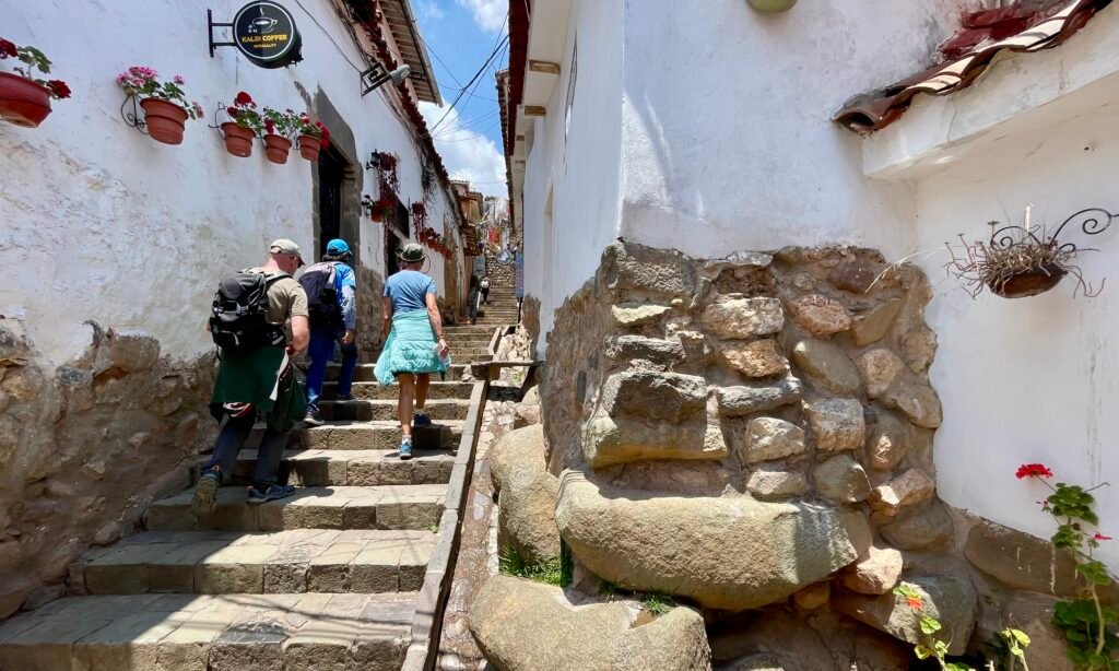 Steep, narrow stone staircase in a quiet Cusco alleyway showing the city's unique mountain topography on the way to San Blas during a free walking tour of Cusco