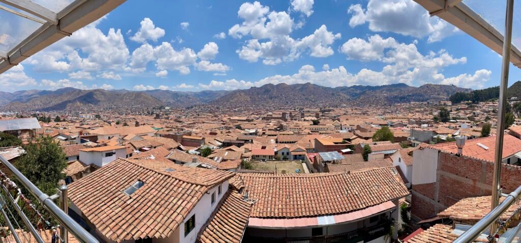 Panoramic city view of Cusco rooftops and hillside neighborhoods captured from Limbus Restobar in the San Blas district.