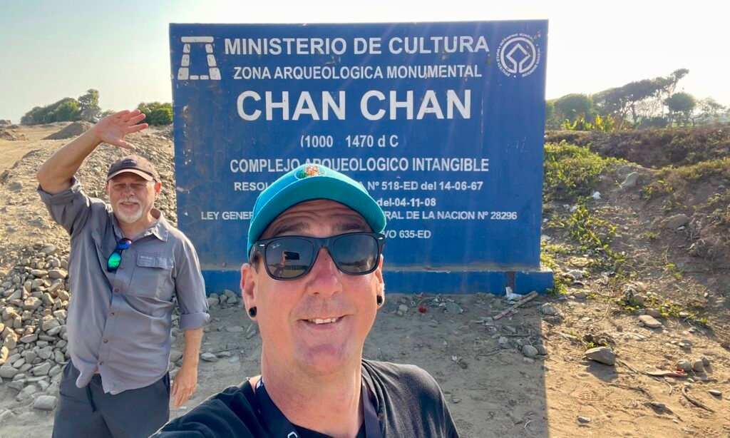 Dave and I standing in front of the sign at the Chan Chan archaeological site near Trujillo, Peru.