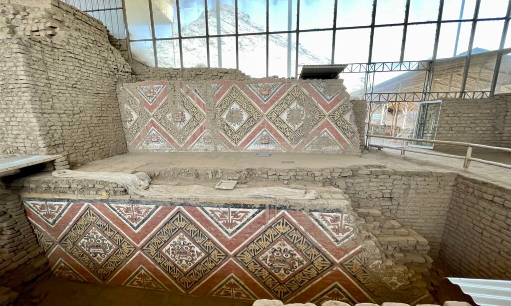 Intricate and colorful adobe friezes on the walls of Huaca de la Luna.