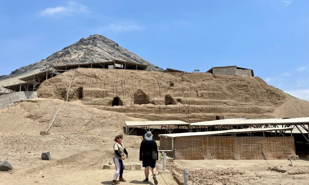 Looking up at the massive, stepped structure of the Huaca del Sol.