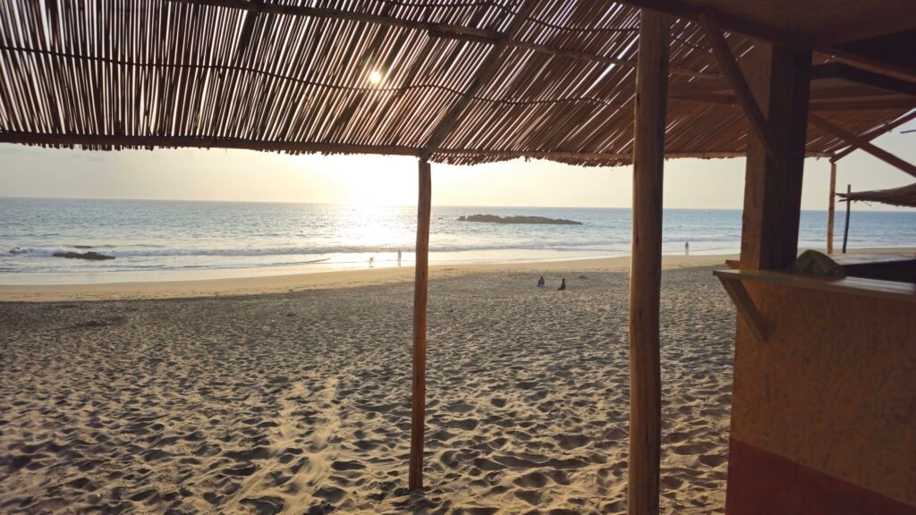 A late afternoon view of the Pacific Ocean from Playa Colorado in Huacho, Peru, with the rugged coastline and local atmosphere.