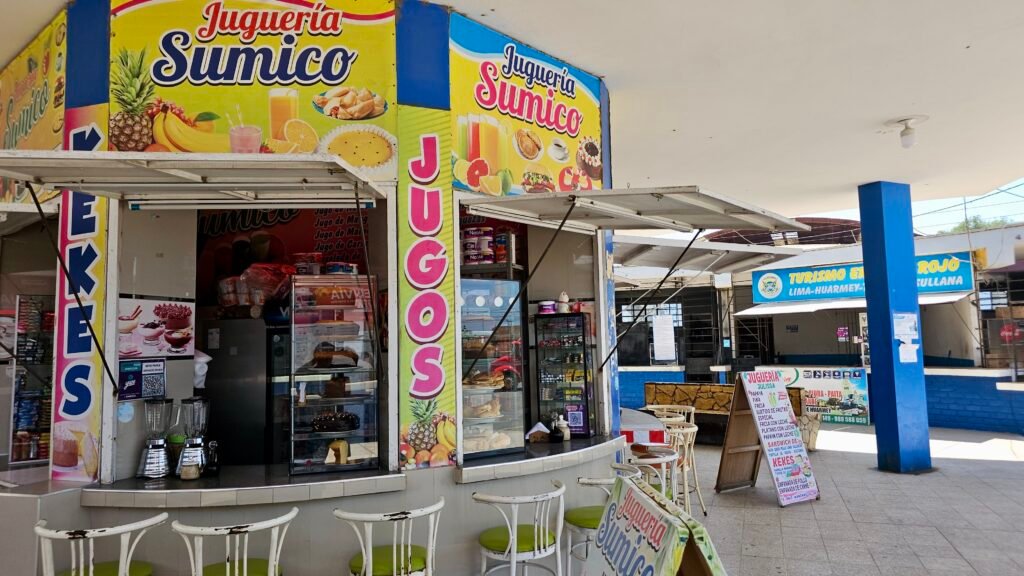 A colorful juice and snack stand called Juguería Sumico inside the bus station in Huarmey, Peru.