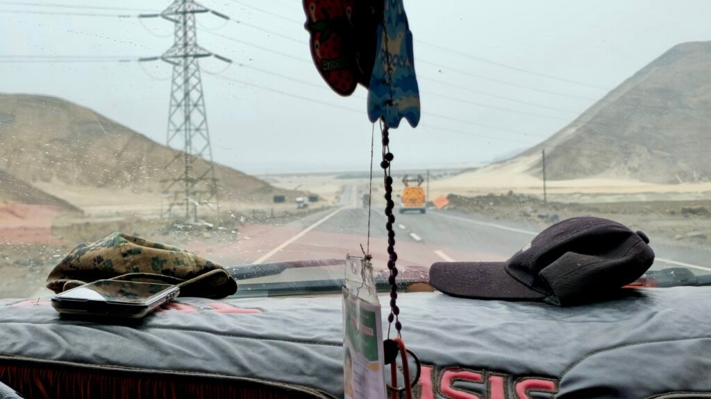 The view from the road looking out onto the open Pan-American Highway desert landscape while traveling north in Peru.