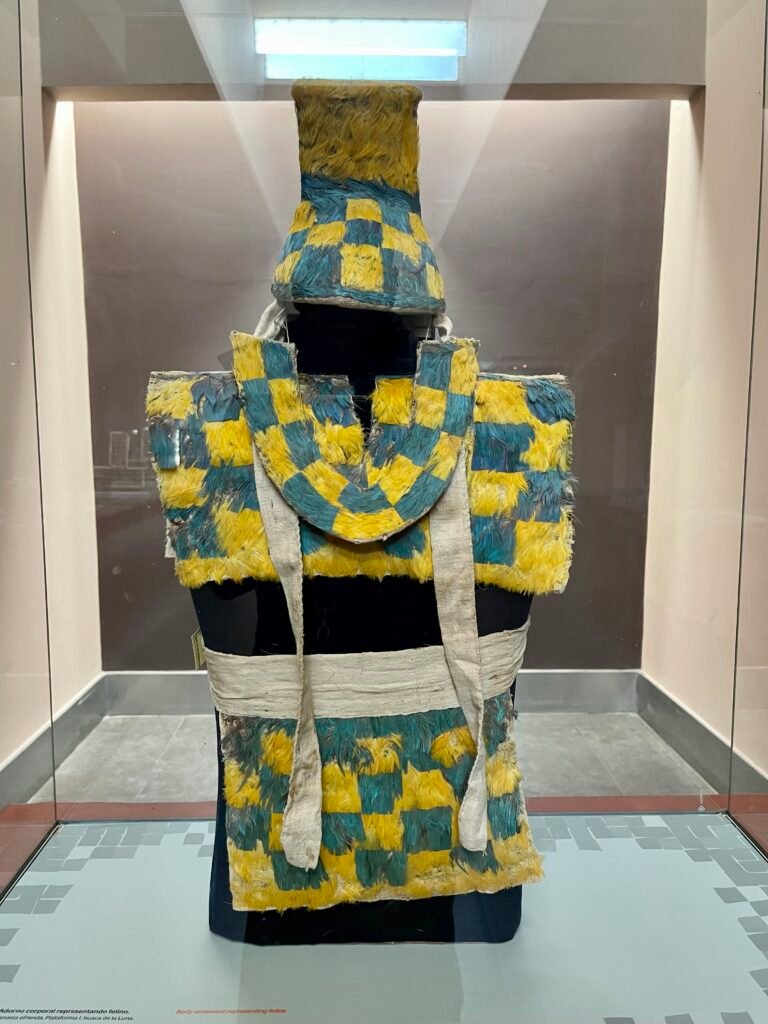 An ancient feathered ceremonial suit worn by a high-ranking Moche official, displayed at the Moche Museum.