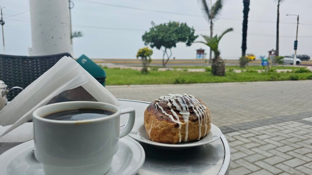 Fresh coffee and pastry at Panadería Argolini, a local bakery and cafe in Punta Huanchaco, overlooking the ocean.