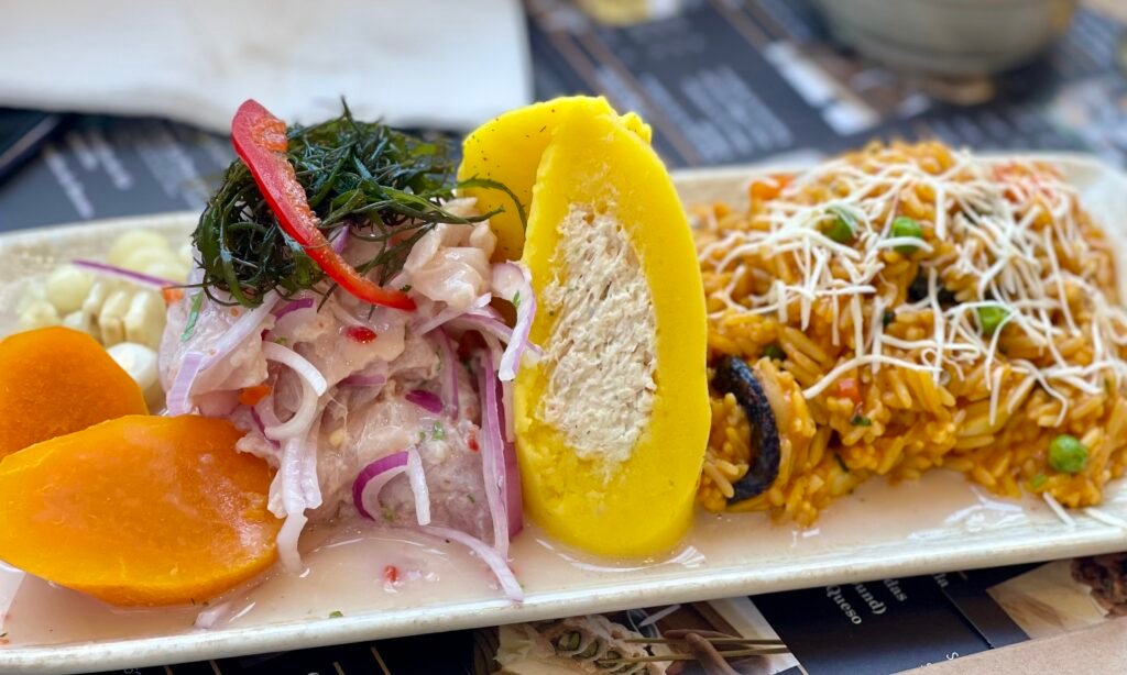A beautifully plated ceviche with causa, sweet potato, and fresh seafood.