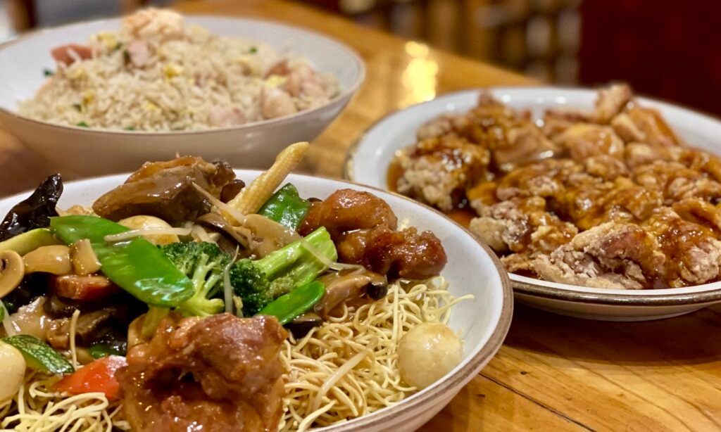 A spread of Peruvian-Chinese fusion (Chifa) dishes including fried rice and stir-fry.