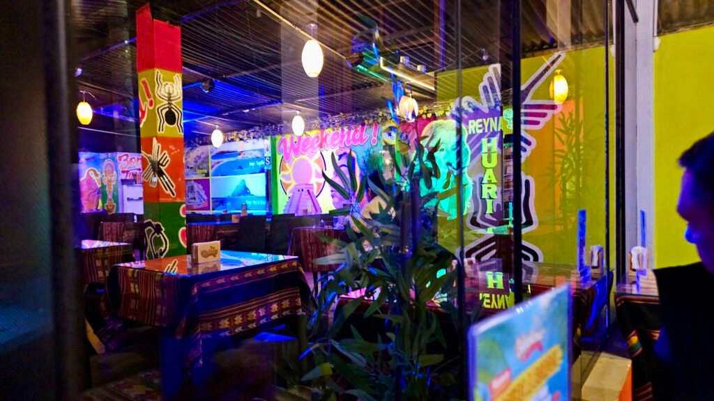 The vibrant, colorful interior of The Weekend bar in Huarmey, captured in the early evening before the crowd arrives.